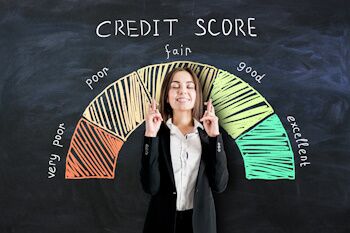 woman crossing fingers in front of credit score report