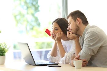 worried couple looking at credit score online