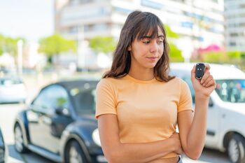 young woman frustrated holding car keys