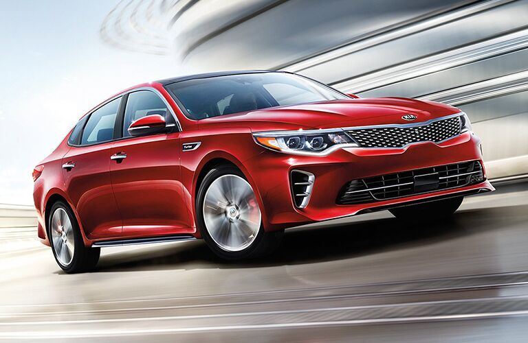 2018 Kia Optima driving quickly around a corner
