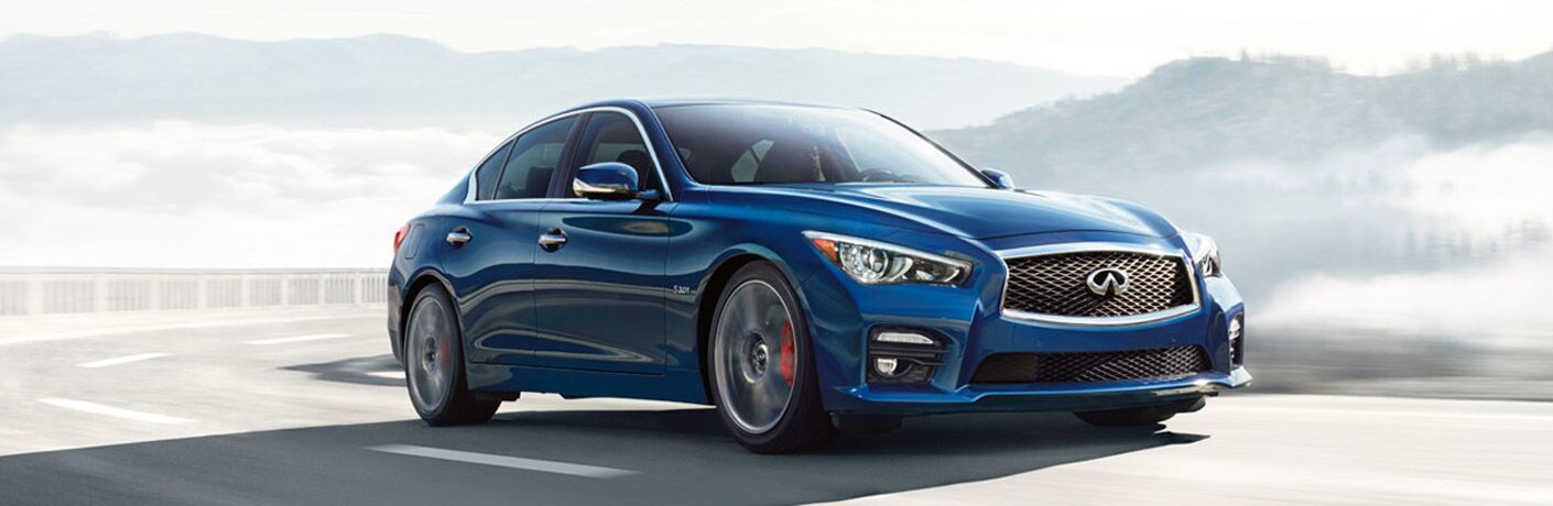 Blue 2019 INFINITI Q50 driving on a mountainous road