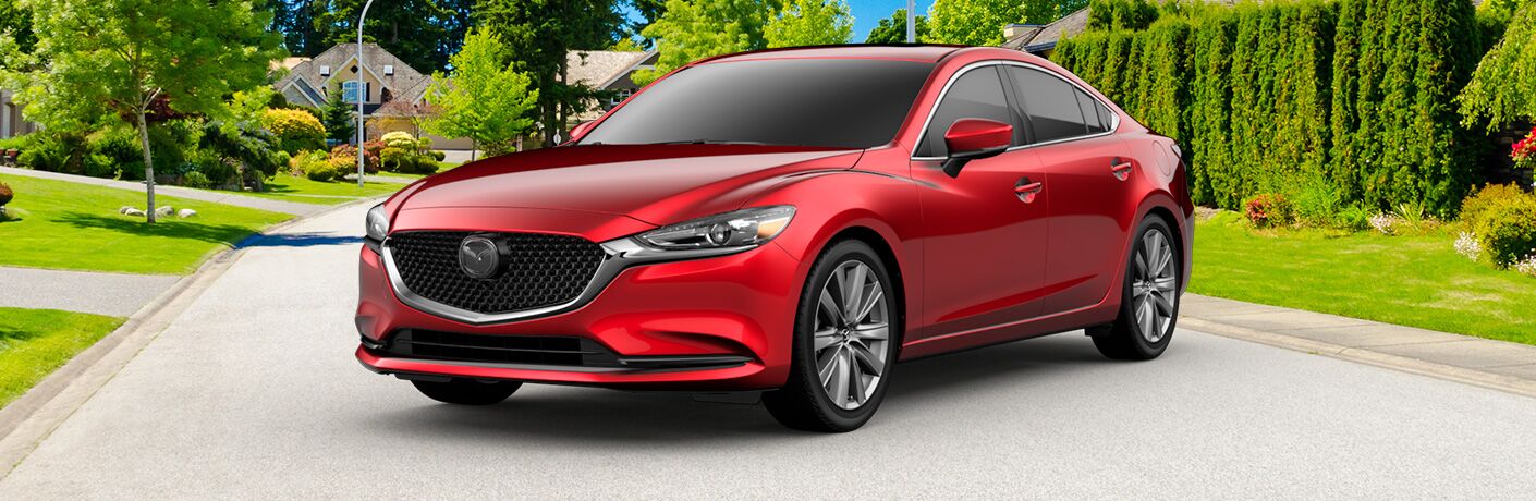 Red 2019 Mazda6 parked in the middle of a residential street