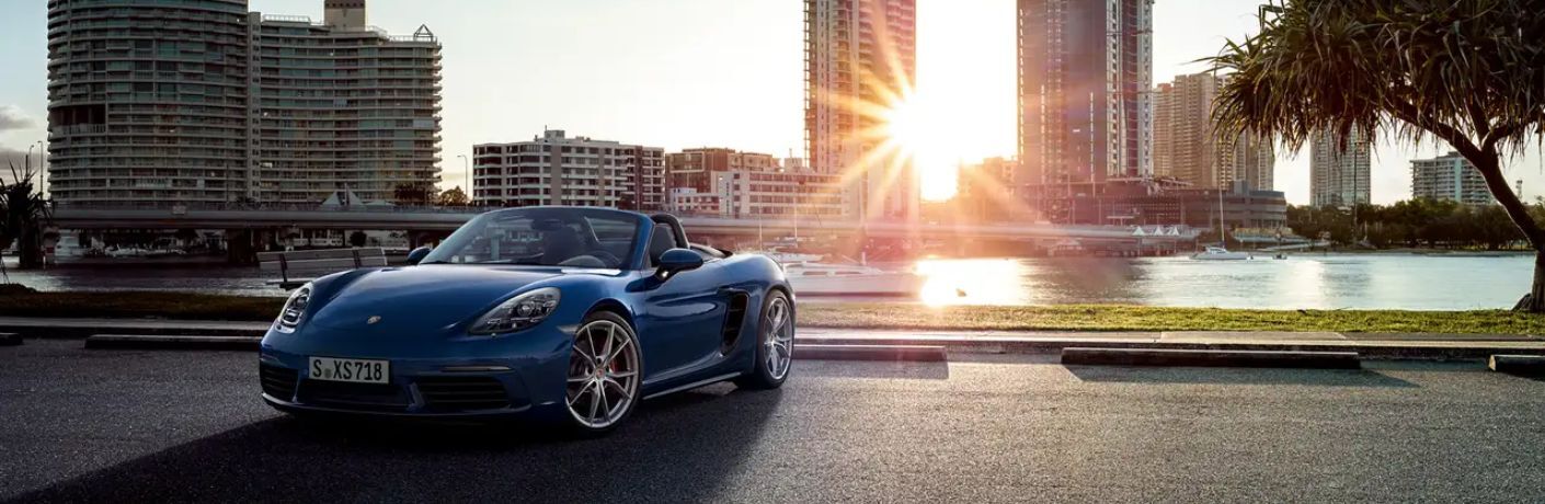 Front view of the 2024 Porsche 718 near a building
