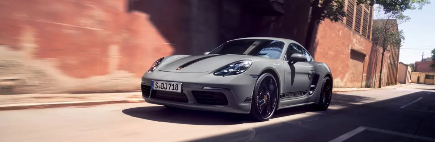 A 2024 Porsche 718 Cayman S speeding on a road