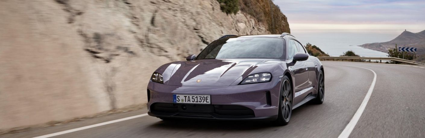 A 2025 Porsche Taycan speeding on a road