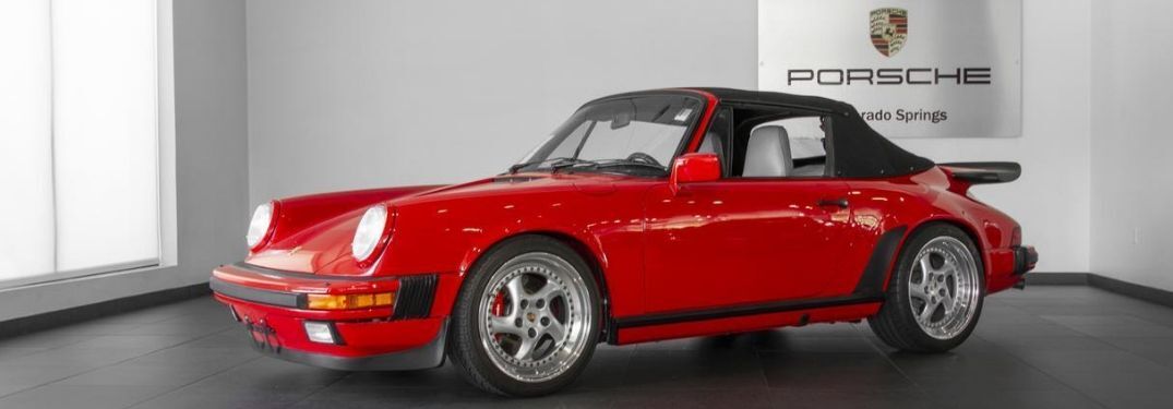 1988 Porsche 911 Carrera Cabriolet viewed from side on showroom floor