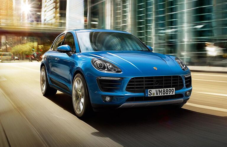 Blue 2019 Porsche Macan driving down road