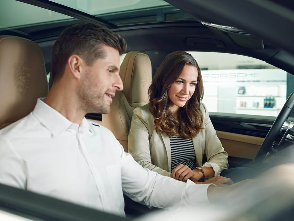 A couple sitting in a Porsche in ,