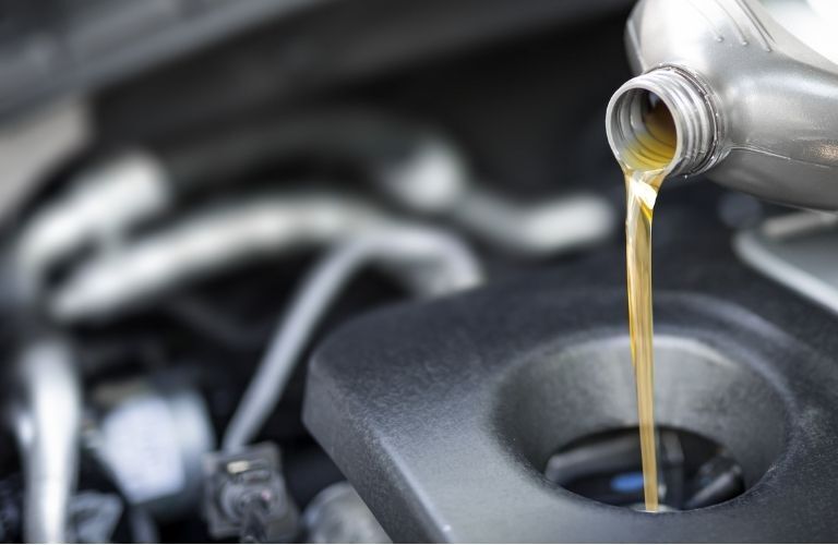 Oil being poured into the vehicle