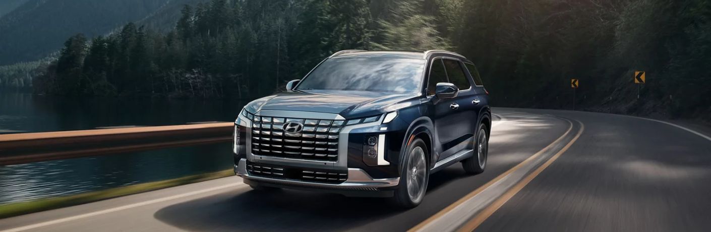 A 2023 Hyundai Palisade on a smooth curved road