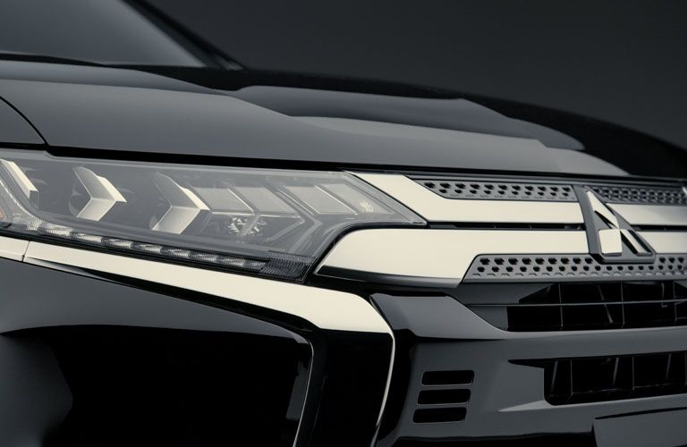 2020 Mitsubishi Outlander close up of front of vehicle grille and headlights