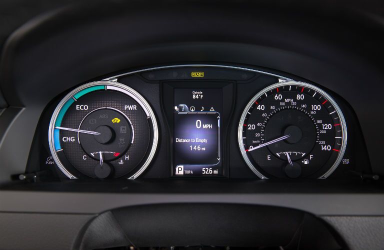 A photo of the center gauge cluster in the Toyota Camry Hybrid.