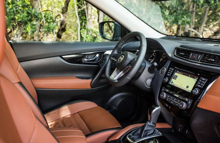 An interior photo of the driver's cockpit in the used Nissan Rogue.