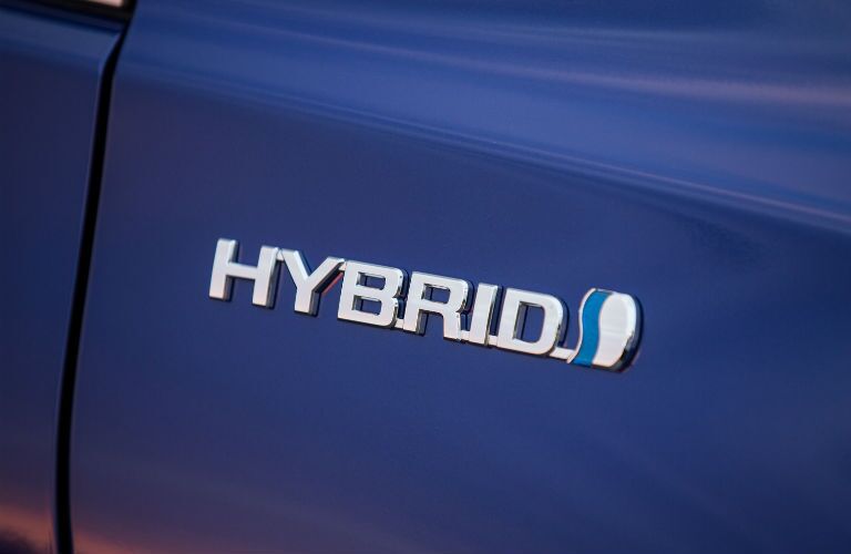 A photo of the hybrid badge worn by the Toyota Camry Hybrid.