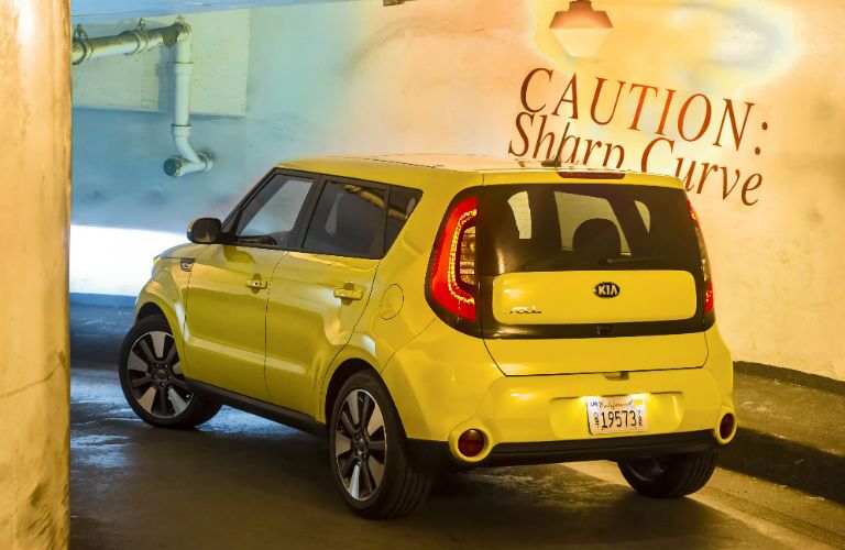 A rear left quarter photo of the used Kia Soul leaving a parking garage.