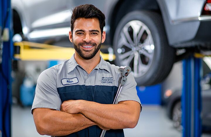 service technician working on engine with socket wrench