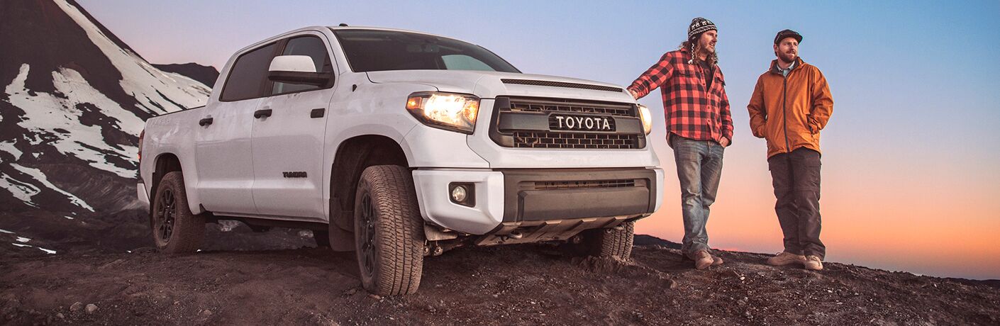 Two men standing next to the 2017 Toyota Tundra on a hill