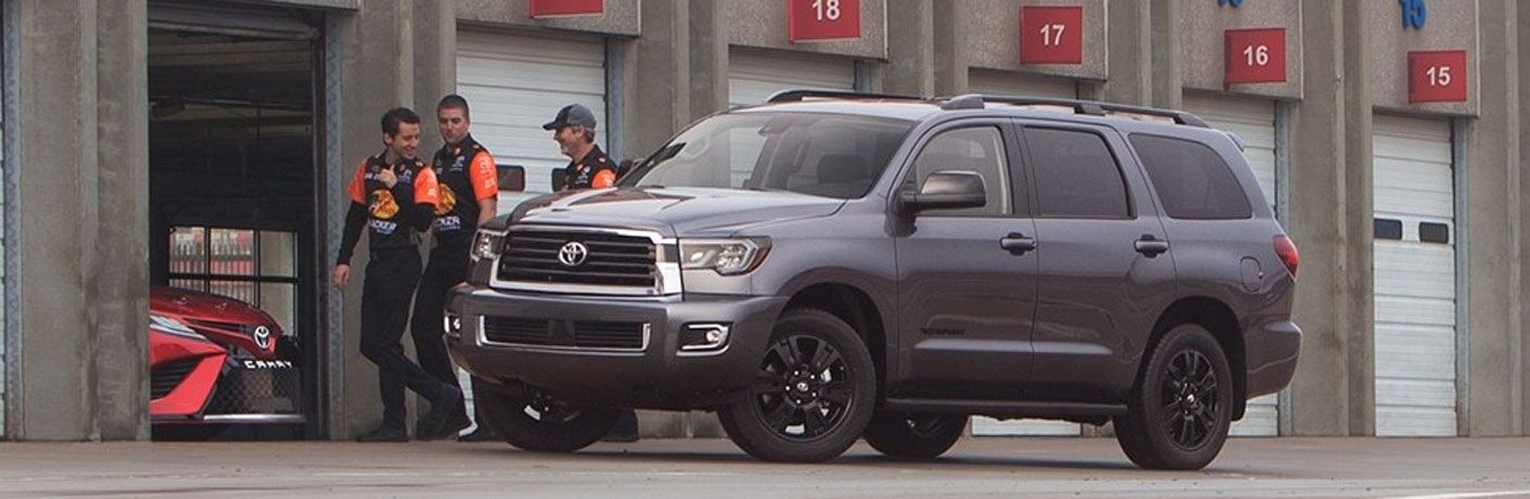 Three men walking away from a parked 2018 Toyota Sequoia