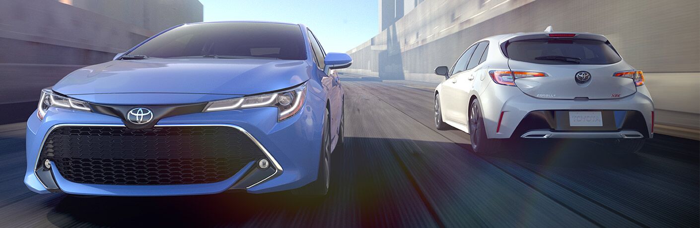 Blue 2019 Toyota Corolla driving next to a white Toyota Corolla