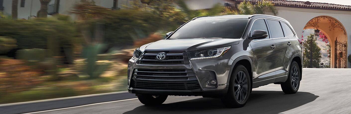 2019 Toyota Highlander driving down a street