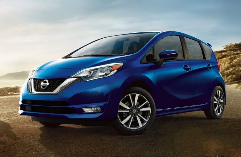 Front driver angle of a blue 2019 Nissan Versa Note parked on a beach