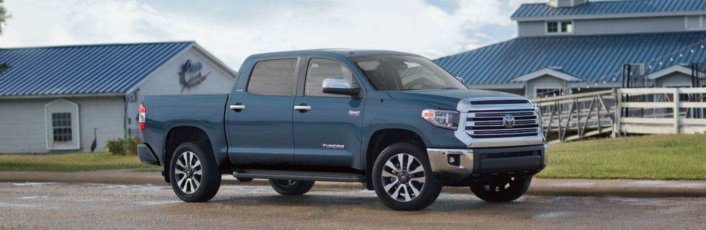 Blue 2019 Toyota Tundra parked in front of house with blue roof