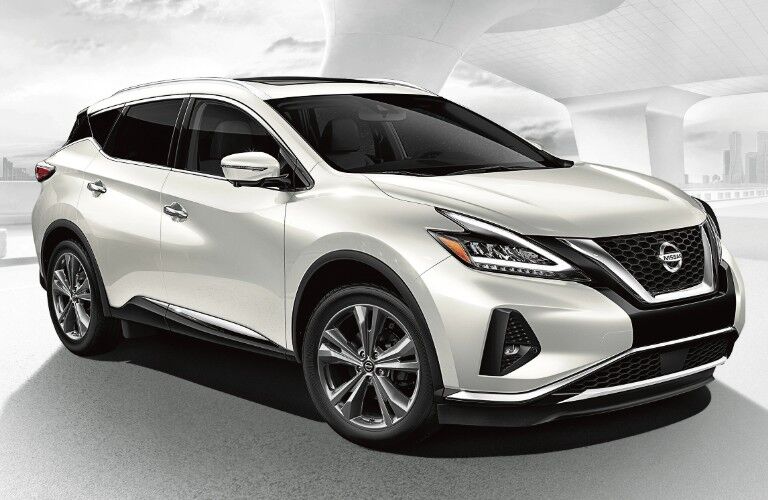 Front passenger angle of a white 2020 Nissan Murano on a white and grey background