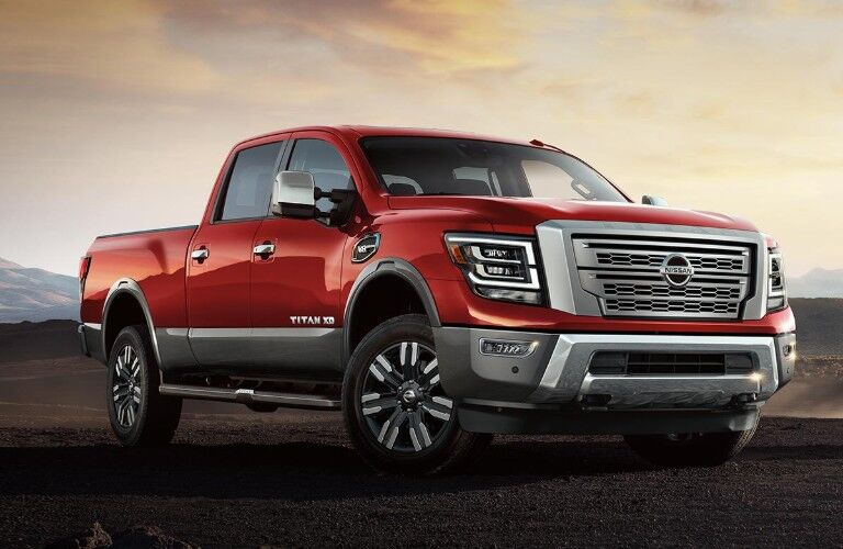 Front passenger angle of a red 2020 Nissan TITAN XD parked outdoors