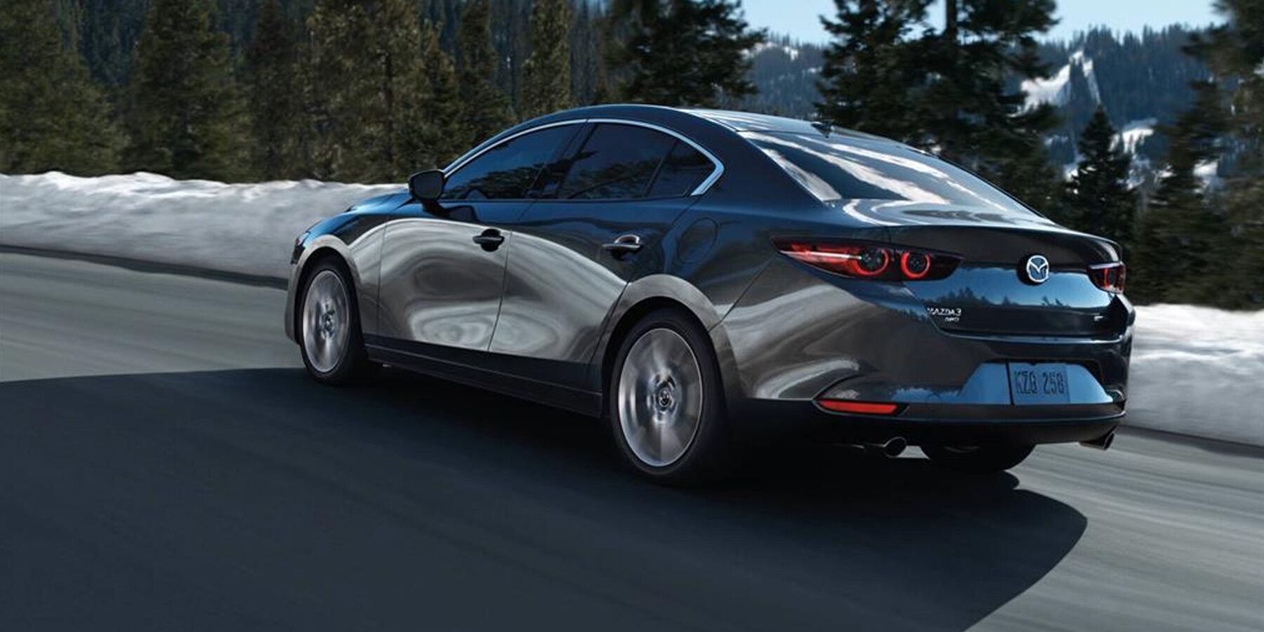 2020 Mazda3 driving down a city street