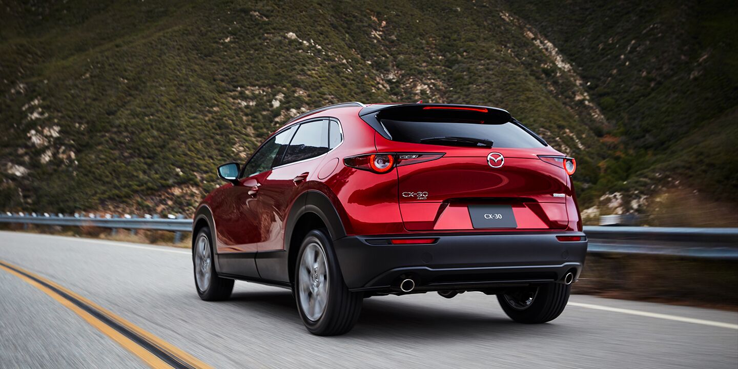 Mazda CX-30 driving down a rural highway near Oshkosh, WI