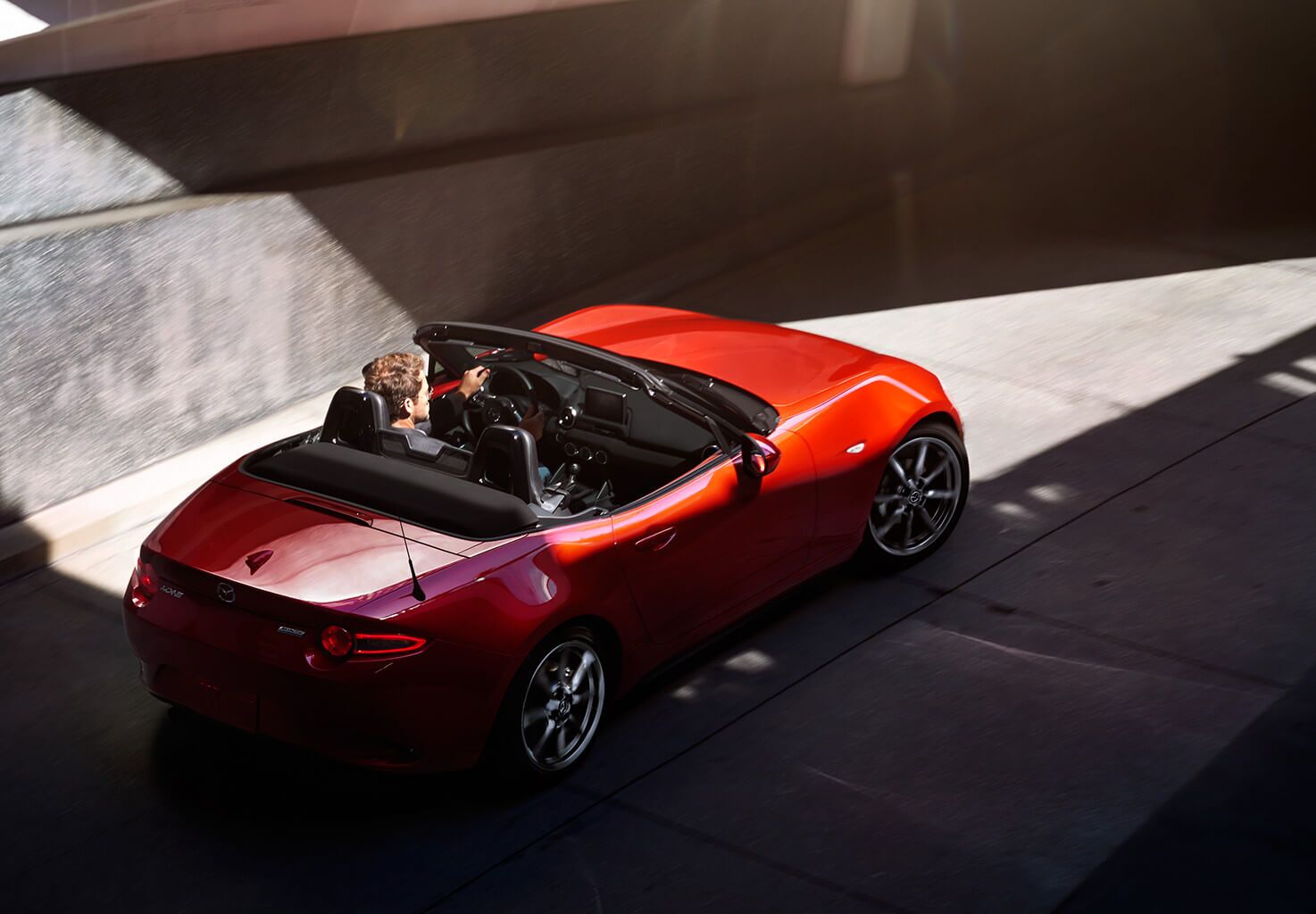 Soul red Mazda MX-5 going through a tunnel
