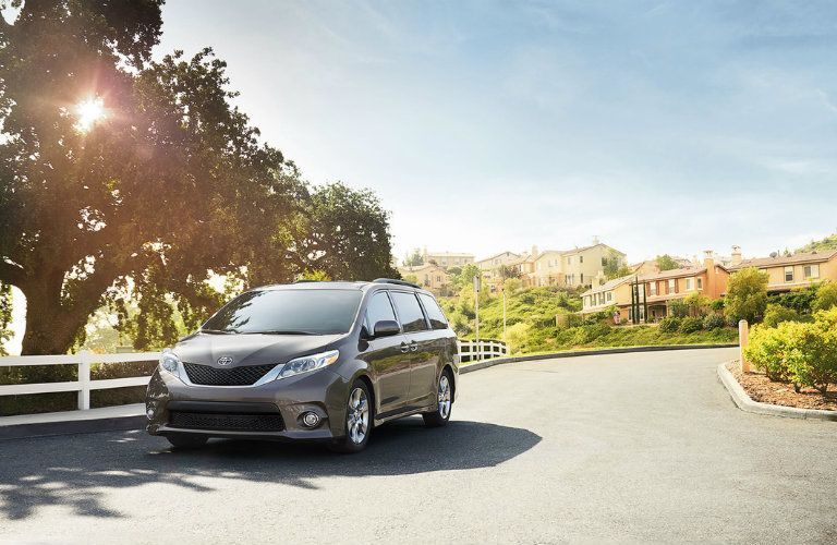 gray 2016 Toyota Sienna driving on suburban street