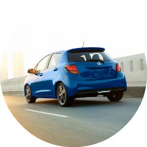 blue 2017 Toyota Yaris driving on road