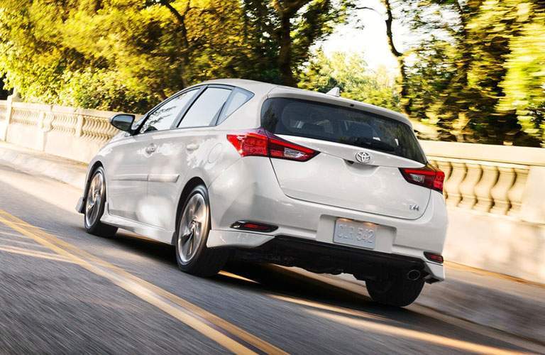 white 2018 Toyota Corolla iM rear end driving across bridge