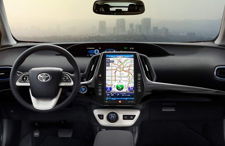 2018 Toyota Prius steering wheel, dashboard with skyline through windshield