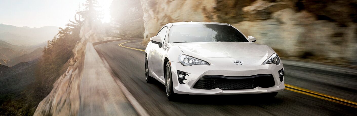 White 2019 Toyota 86 driving on a mountainous road