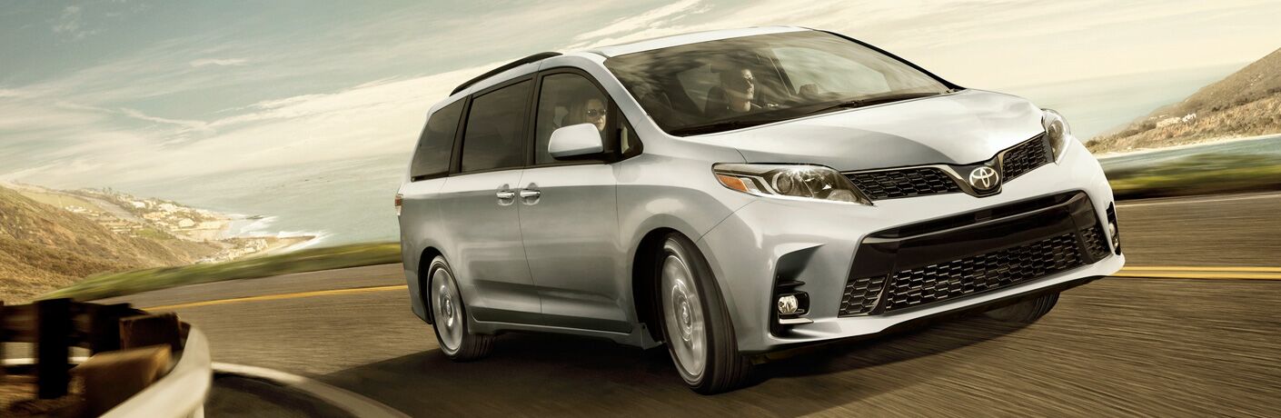 Silver 2019 Toyota Sienna driving on a coastal road