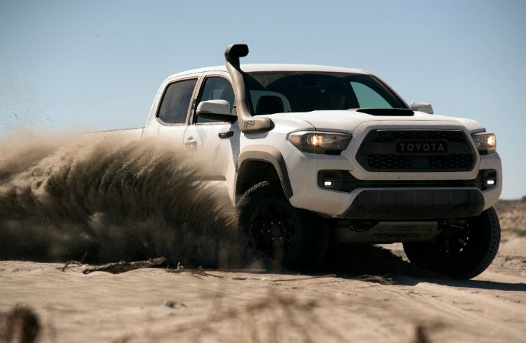 white 2018 Toyota Tacoma TRD Pro kicking up sand