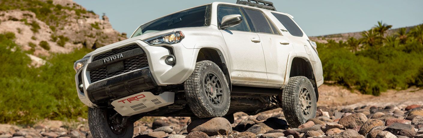 White 2020 Toyota 4Runner driving over rocks