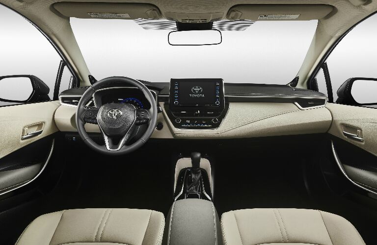 Dashboard and white front seats in 2020 Toyota Corolla