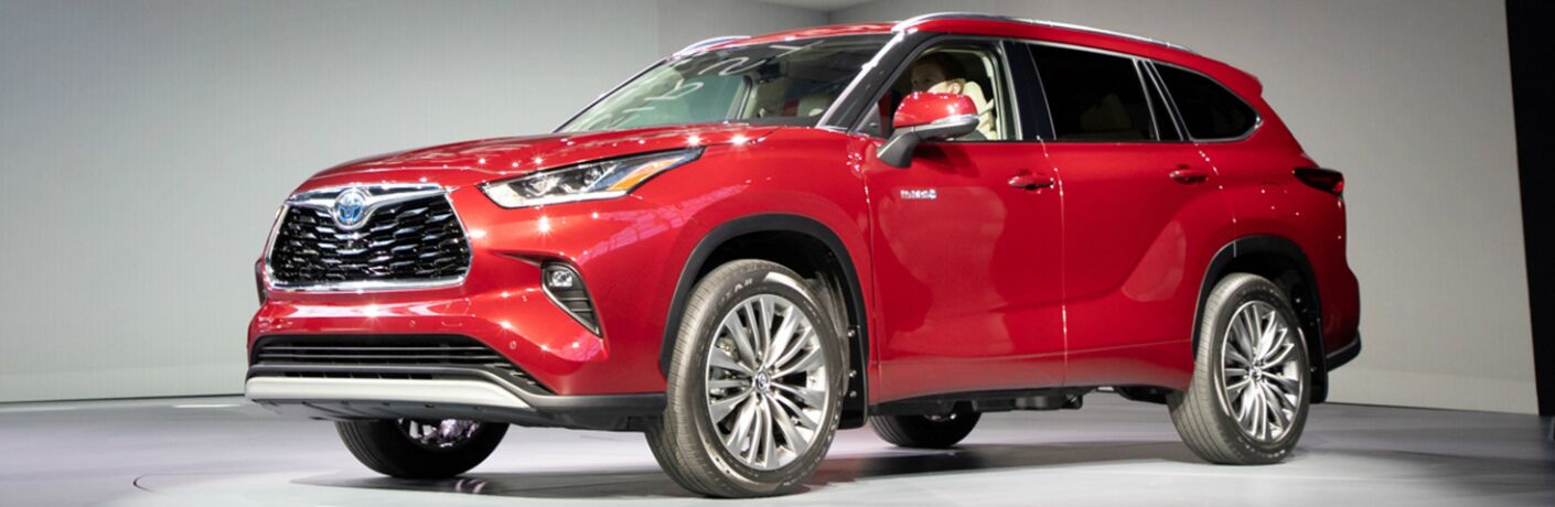 Driver's side front angle view of red 2020 Toyota Highlander Hybrid