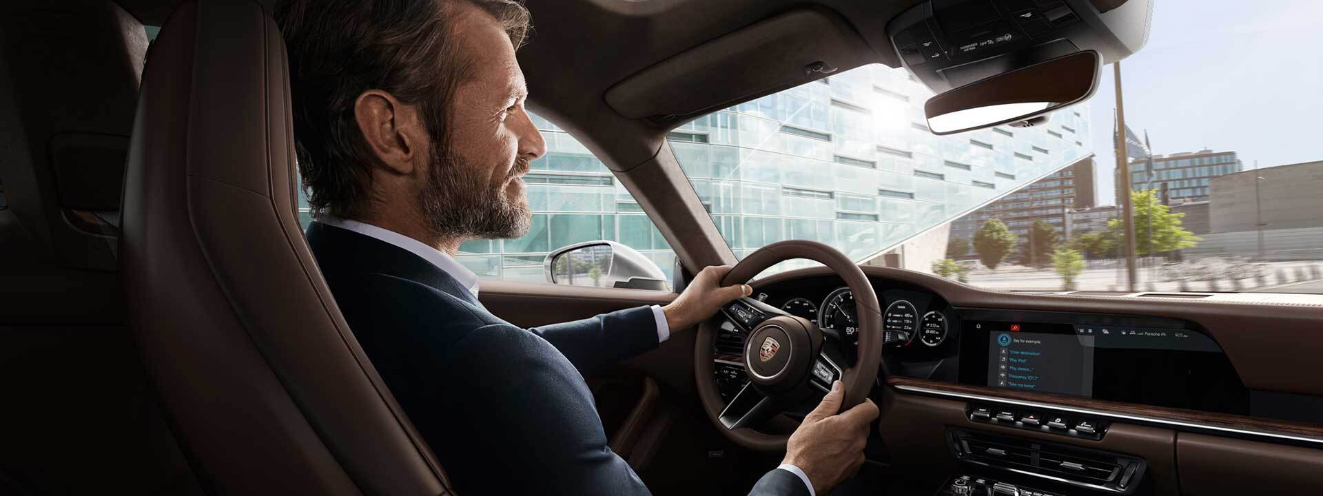 A man sitting in a Porsche in ,