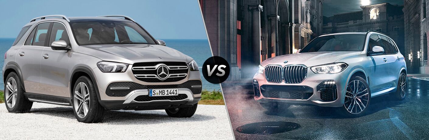 2020 MB GLE SUV exterior front fascia and passenger side on beach vs 2019 BMW X5 exterior front fascia and drivers side on town road