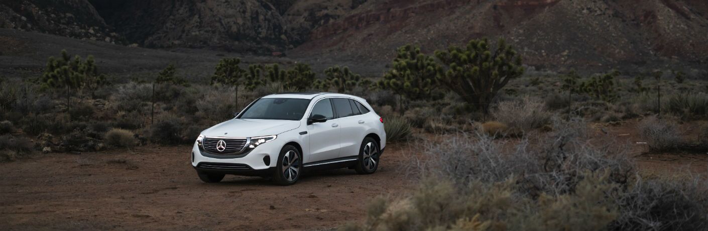 2020 MB EQC exterior front fascia and drivers side parked out in wilderness