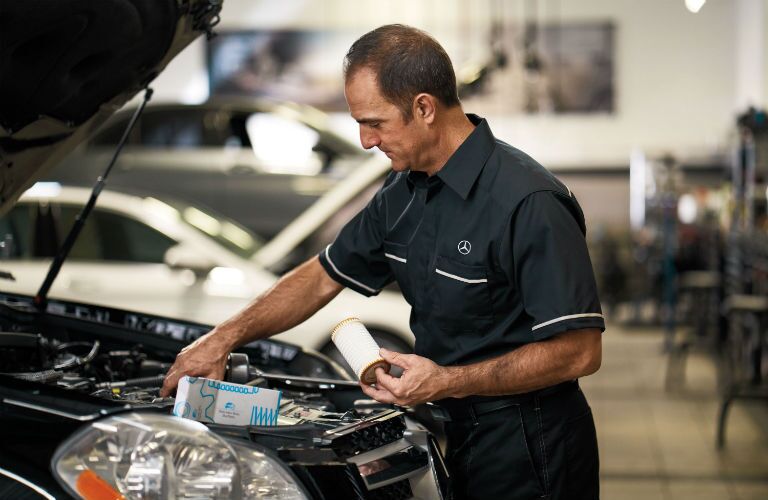 Mercedes-Benz mechanic installing an air filter