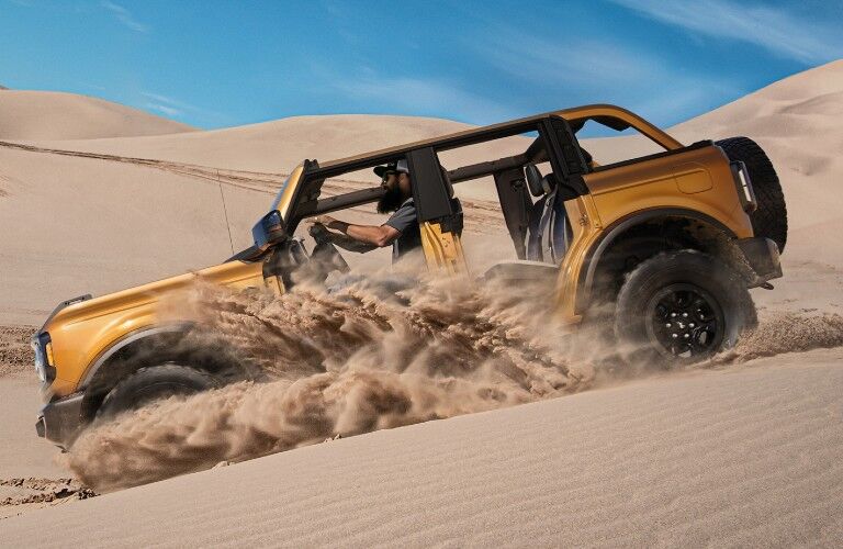 2021 Ford Bronco driving down desert dune