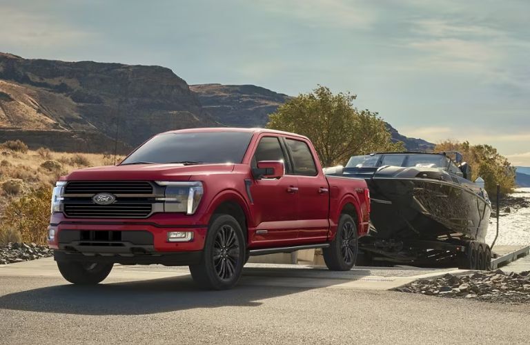 2024 Ford F-150 Red towing a boat