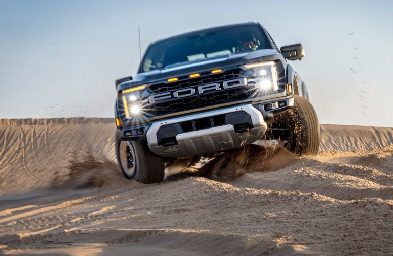 2024 Ford F-150 Raptor truck driving in sand