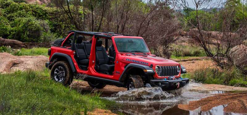 A side view of the 2025 Jeep Wrangler fording a creek.