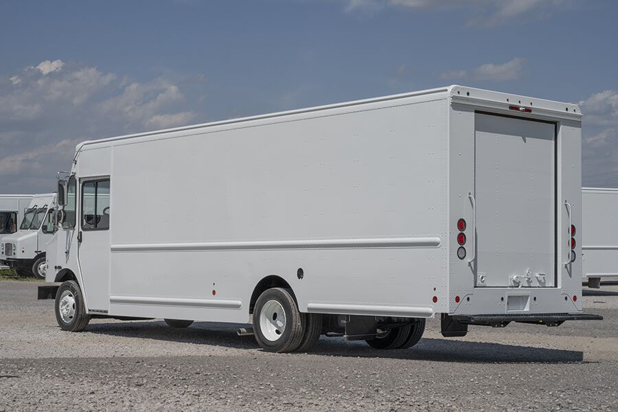 Rear and side view of a step van in a parking lot